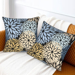 Black, light blue and cream dahlia pattern velvet pillow covers styled on a sofa