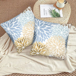 Light blue, cream and gold dahlia pattern velvet pillow covers styled on a woven chair