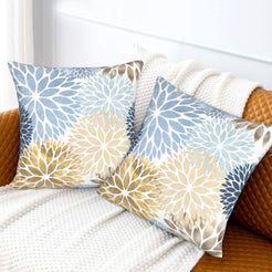 Light blue, cream and gold dahlia pattern velvet pillow covers styled on a sofa