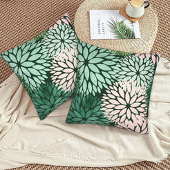 Dark green, mint and blush dahlia pattern velvet pillow covers styled on a woven chair