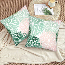 Mint, green and blush dahlia pattern velvet pillow covers styled on a woven chair