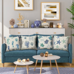 water-resistant linen-look polyester pillow covers with blue and green coastal sea-life prints, styled on a teal sofa