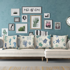 water-resistant linen-look polyester pillow covers with blue and green coastal sea-life prints, styled on a white sectional