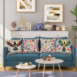 Short-pile plush pillow covers with colorful folk birds and flowers on cream, styled on a teal sofa