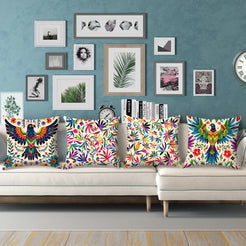 Short-pile plush pillow covers with colorful folk birds and flowers on cream, styled on a cream sectional