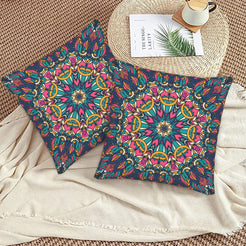 Navy teal and coral floral mandala design velvet pillow covers styled on a woven chair