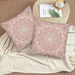 Blush and gray delicate mandala design velvet pillow covers styled on a woven chair