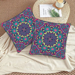 Purple and teal floral mandala design velvet pillow covers styled on a woven chair