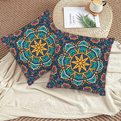 Teal and gold star mandala design velvet pillow covers styled on a woven chair