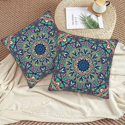 Teal and purple lace mandala design velvet pillow covers styled on a woven chair