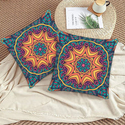Teal and orange sun mandala design velvet pillow covers styled on a woven chair