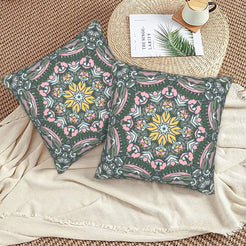 Charcoal and pink botanical mandala design velvet pillow covers styled on a woven chair