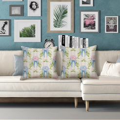 Water-resistant linen-look polyester pillow covers with hydrangea bouquets and blue bows on cream, styled on a white sofa