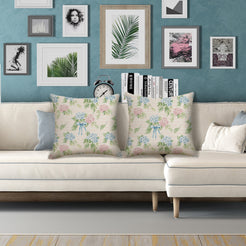 Water-resistant linen-look polyester pillow covers with scattered hydrangeas on cream, styled on a white sofa