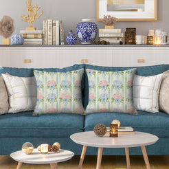 Water-resistant linen-look polyester pillow covers with hydrangeas and bows on green stripes, styled on a blue sofa