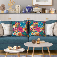 Water-resistant pillow covers with skulls, teal flowers and hibiscus, styled on a blue sofa