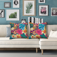 Water-resistant pillow covers with skulls, teal flowers and hibiscus, styled on a white sofa