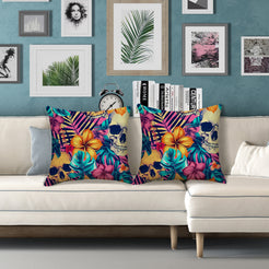 Water-resistant pillow covers with gold skulls, hibiscus and teal leaves, styled on a white sofa