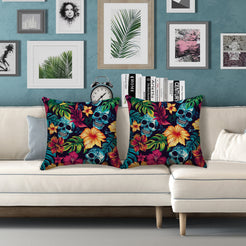 Water-resistant pillow covers with blue skulls, hibiscus and green leaves, styled on a white sofa