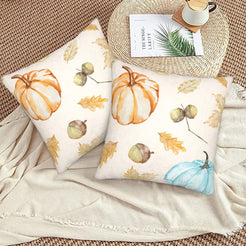 Autumn velvet pillow covers with cream pumpkins, acorns and leaves, styled on a woven chair