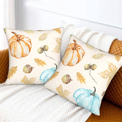 Autumn velvet pillow covers with cream pumpkins, acorns and leaves, styled on a sofa