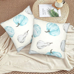 Autumn velvet pillow covers with cream blue and gray pumpkins, styled on a woven chair