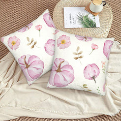 Autumn velvet pillow covers with cream pink pumpkins and flowers, styled on a woven chair