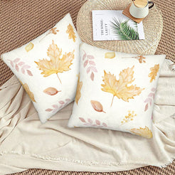 Autumn velvet pillow covers with cream gold maple leaves, styled on a woven chair