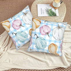 Autumn velvet pillow covers with blue gingham pastel pumpkins, styled on a woven chair