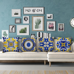 Water-resistant linen-look polyester pillow covers with yellow and blue Moroccan tile patterns, styled on a cream sectional