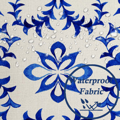 Close-up of water beads on fabric on water-resistant linen-look polyester pillow cover with blue and white floral tiles