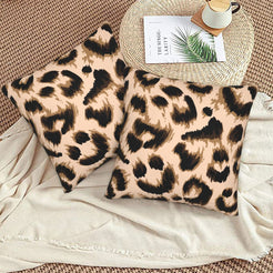Velvet pillow covers with blush brushstroke leopard spots, styled on a beige sofa