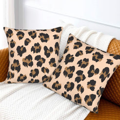 Velvet pillow covers with blush scattered leopard spots, styled on a white sofa