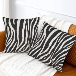 Velvet pillow covers with black and white narrow zebra stripes, styled on a white sofa