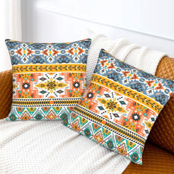 Bohemian velvet pillow covers with turquoise, orange and yellow Aztec bands, styled on a bed