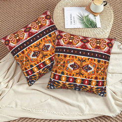 Bohemian velvet pillow covers with red and orange tribal diamonds, styled on a floor cushion