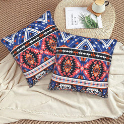 Bohemian velvet pillow covers with navy and coral Aztec medallions, styled on a floor cushion