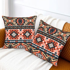 Bohemian velvet pillow covers with black and red Aztec diamonds, styled on a bed