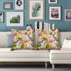 Outdoor water-resistant linen-look polyester pillow covers with birds, lemons and pink flowers, styled on a white sofa