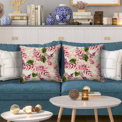 Outdoor water-resistant linen-look polyester pillow covers with burgundy roses, styled on a blue sofa