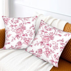 Pink toile velvet pillow covers with pink rose branches on white, styled on a sofa