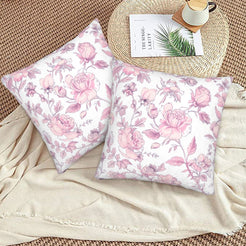 Pink toile velvet pillow covers with pink wildflowers on white, styled on a woven chair
