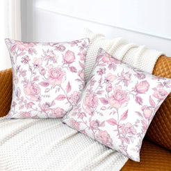 Pink toile velvet pillow covers with pink wildflowers on white, styled on a sofa