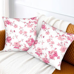 Pink toile velvet pillow covers with pink cherry blossom branches on white, styled on a sofa