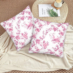 Pink toile velvet pillow covers with pink small floral sprays on white, styled on a woven chair