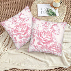 Pink toile velvet pillow covers with pink large roses on white, styled on a woven chair