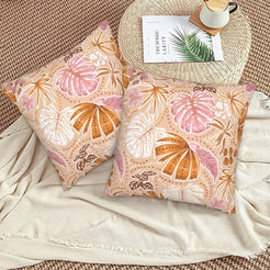 Bohemian floral velvet pillow covers with beige blush tropical leaves, styled on a woven chair