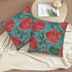 Bohemian floral velvet pillow covers with teal red poppies, styled on a woven chair