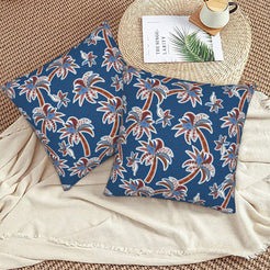 Bohemian floral velvet pillow covers with navy palm trees, styled on a woven chair