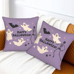 Halloween pillow covers with purple ghosts and skeleton with a Happy Halloween message, styled on a sofa